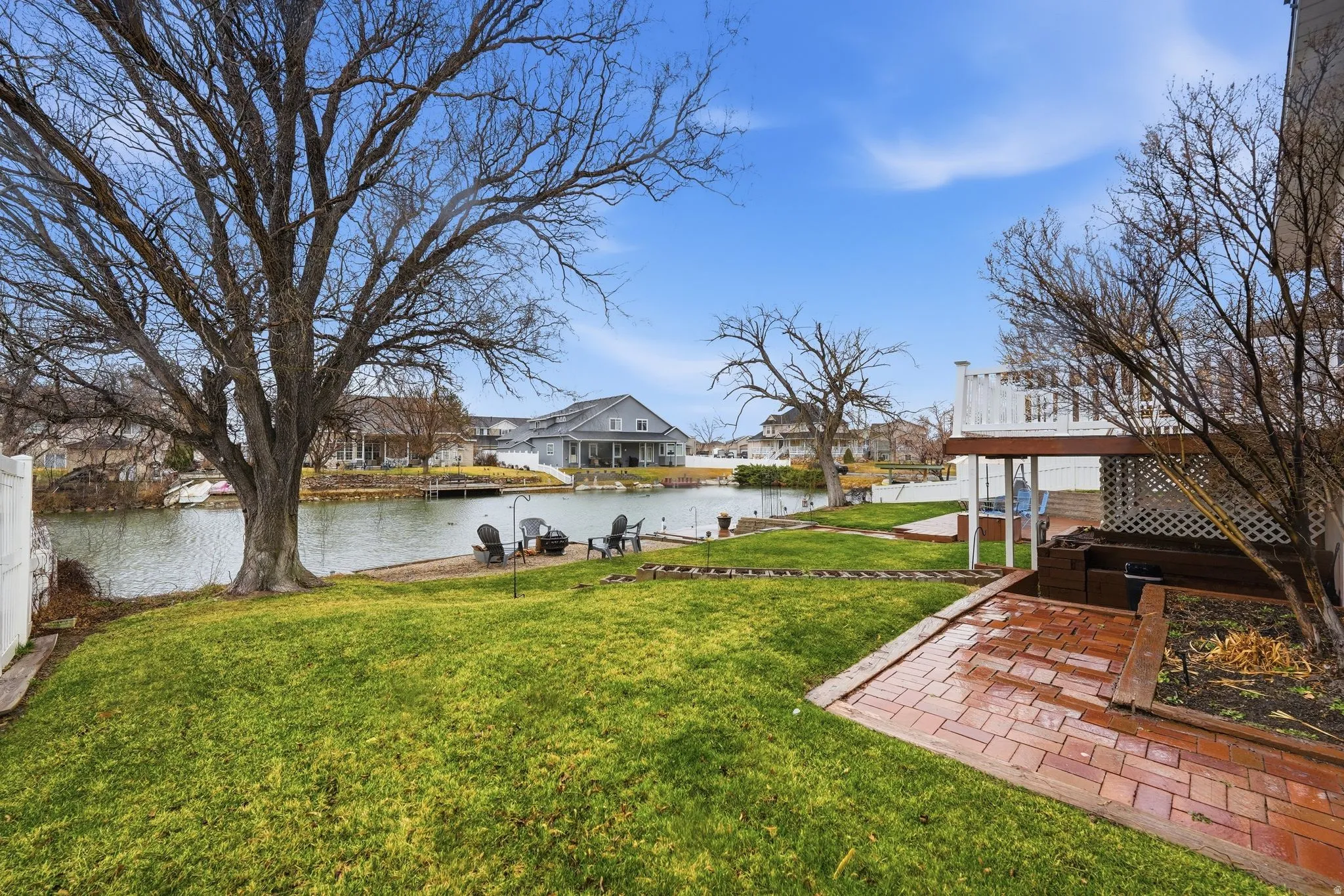 View of green lawn with a water view and a residential view