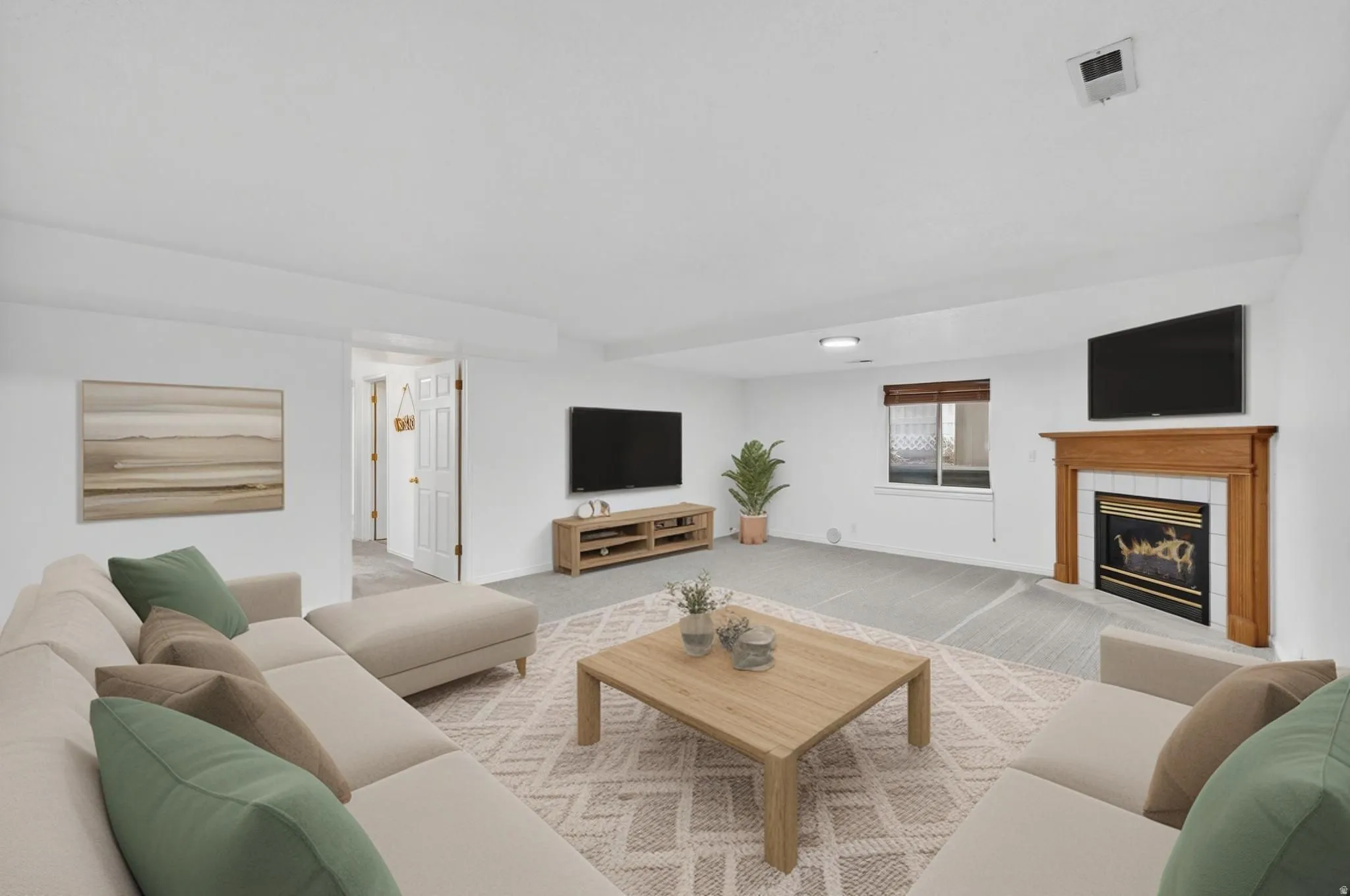 Carpeted living area with a fireplace and baseboards