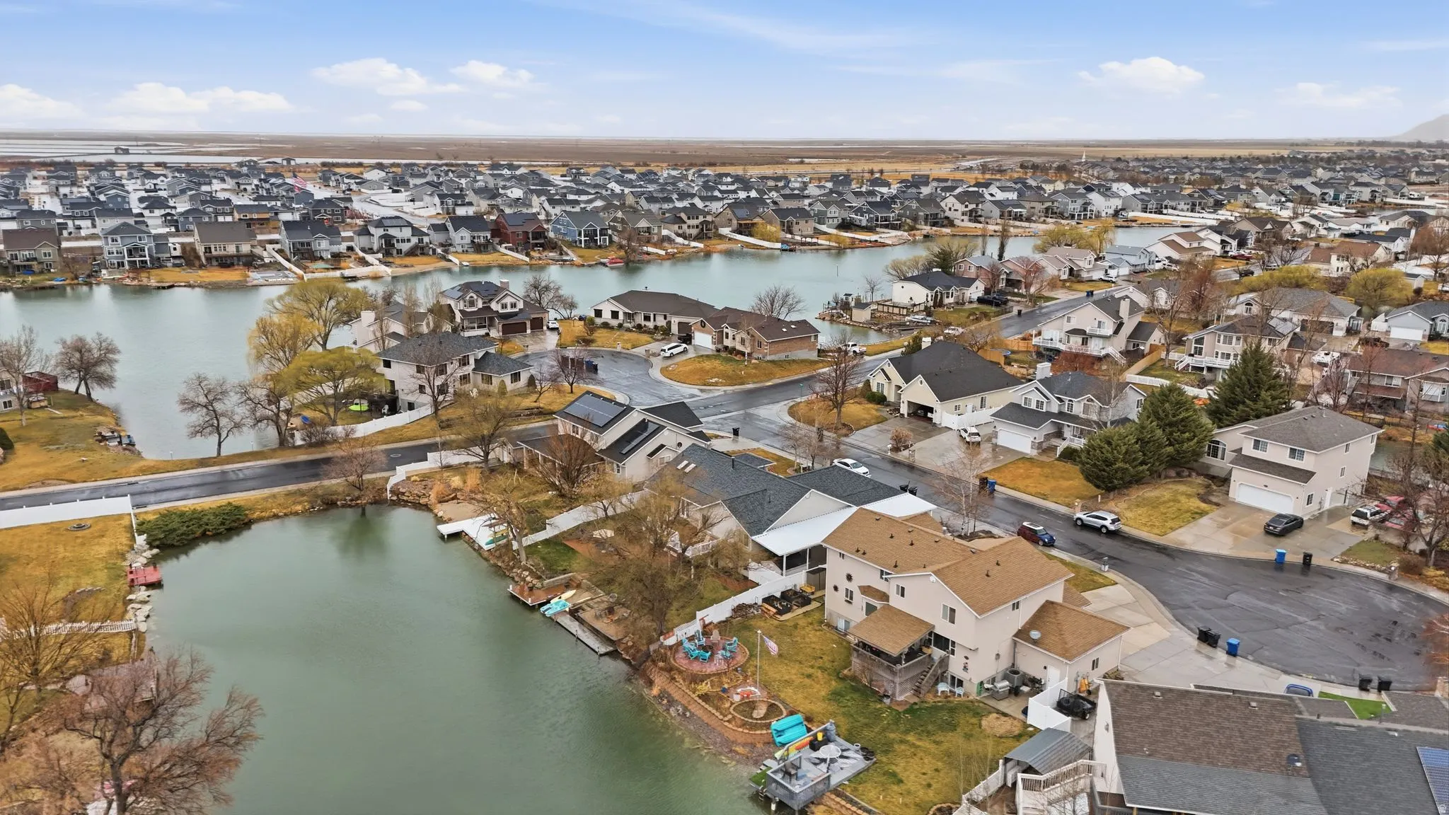 Aerial view of property's location featuring nearby suburban area and a nearby body of water