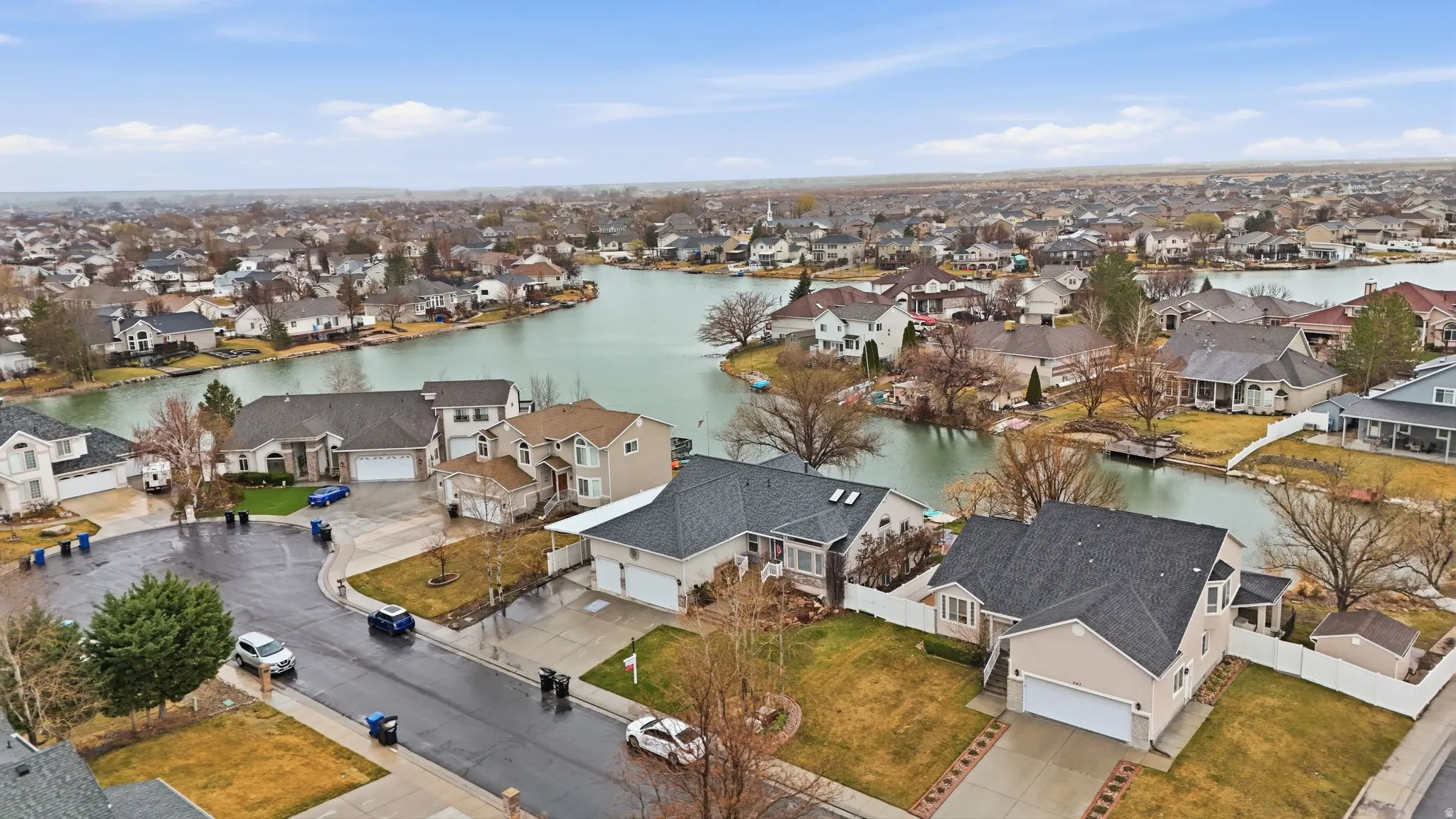 Aerial perspective of suburban area featuring a nearby body of water