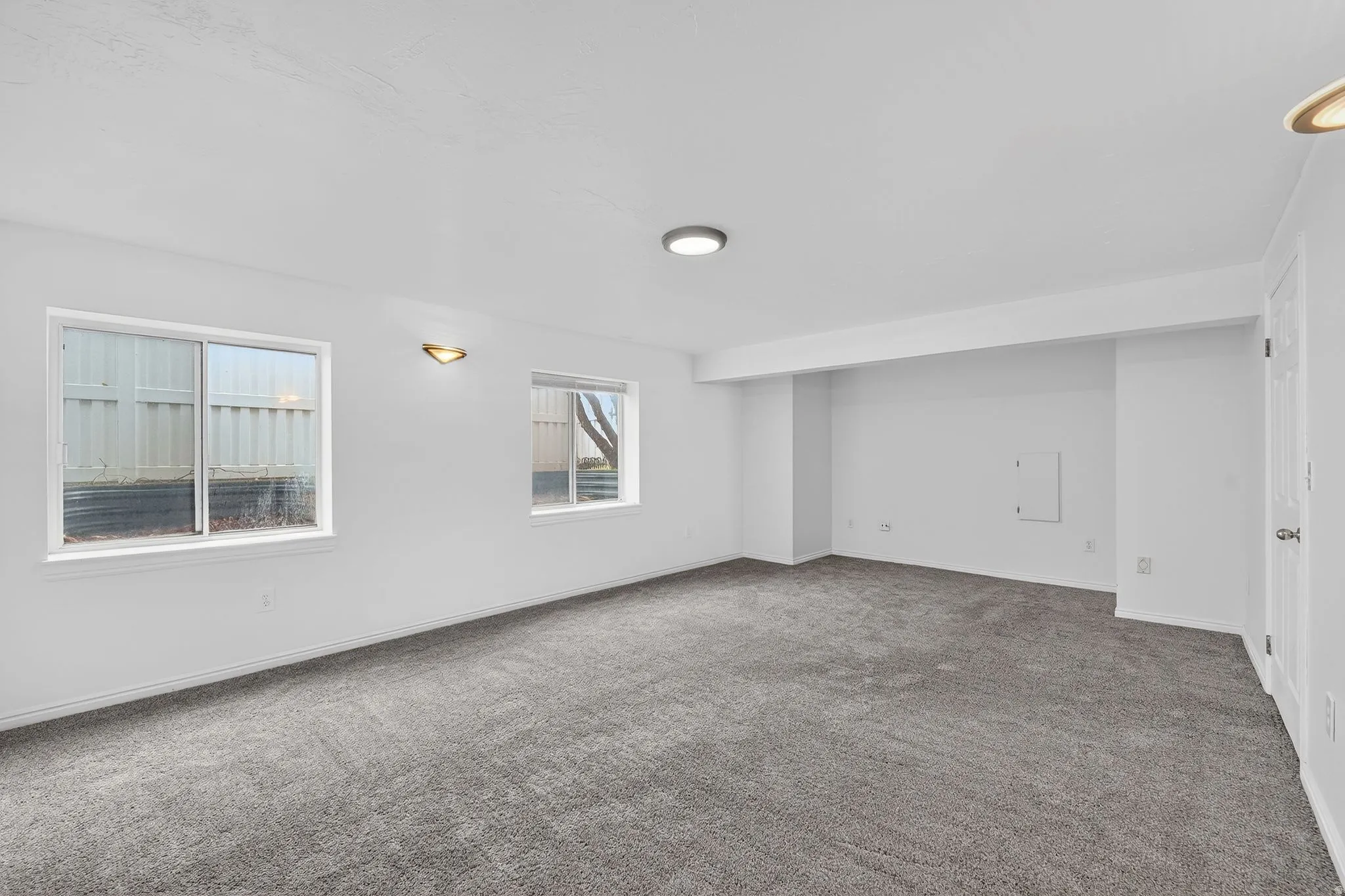 Spare room featuring carpet floors and baseboards