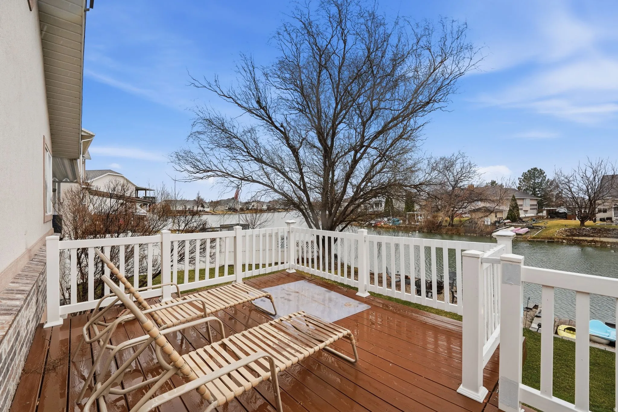 Wooden terrace featuring a residential view and a water view