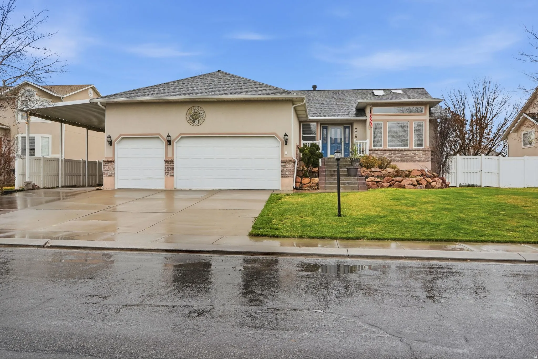 Ranch-style home featuring roof with shingles, a garage, driveway, and stucco siding
