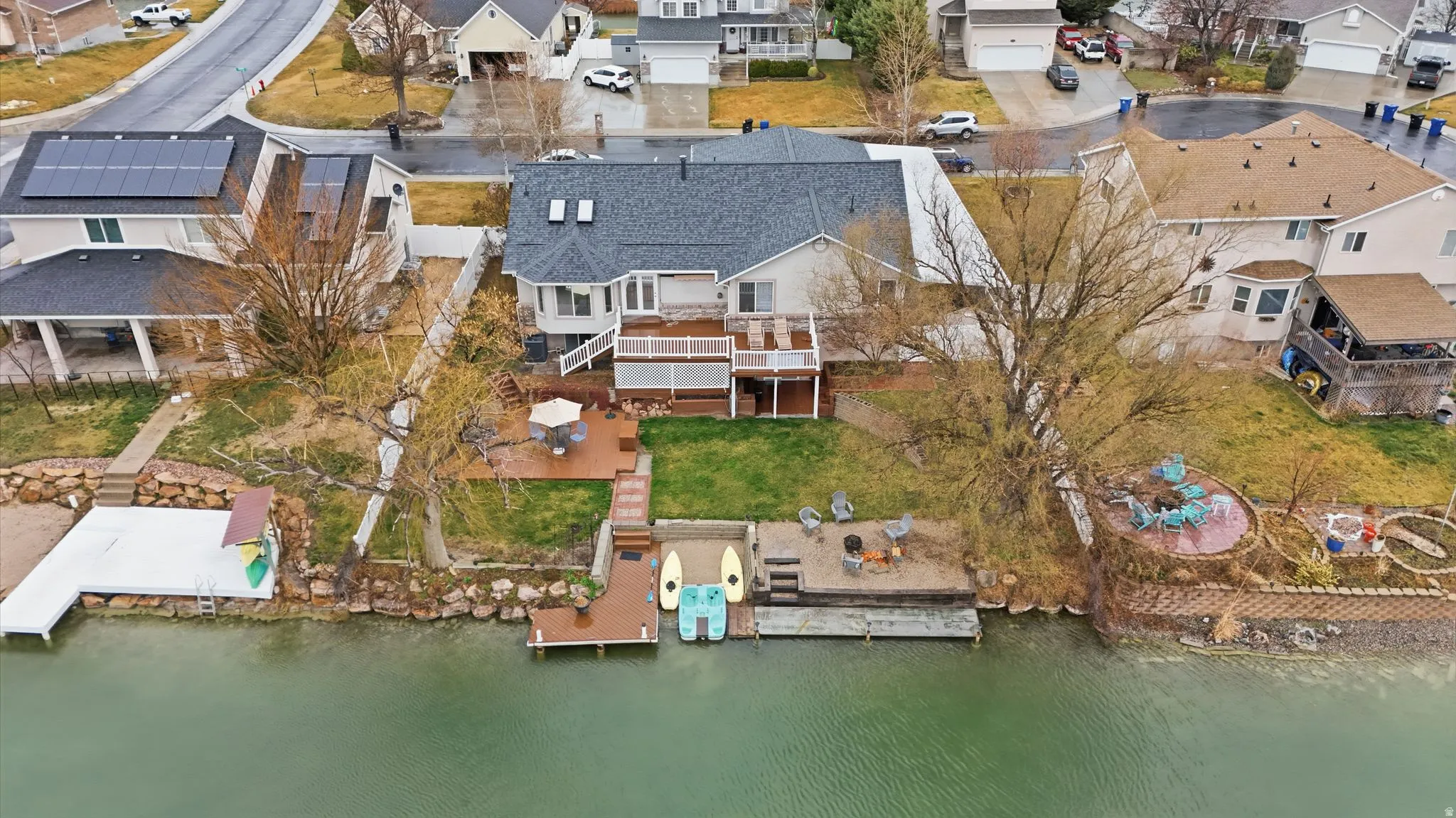 Aerial perspective of suburban area featuring a large body of water