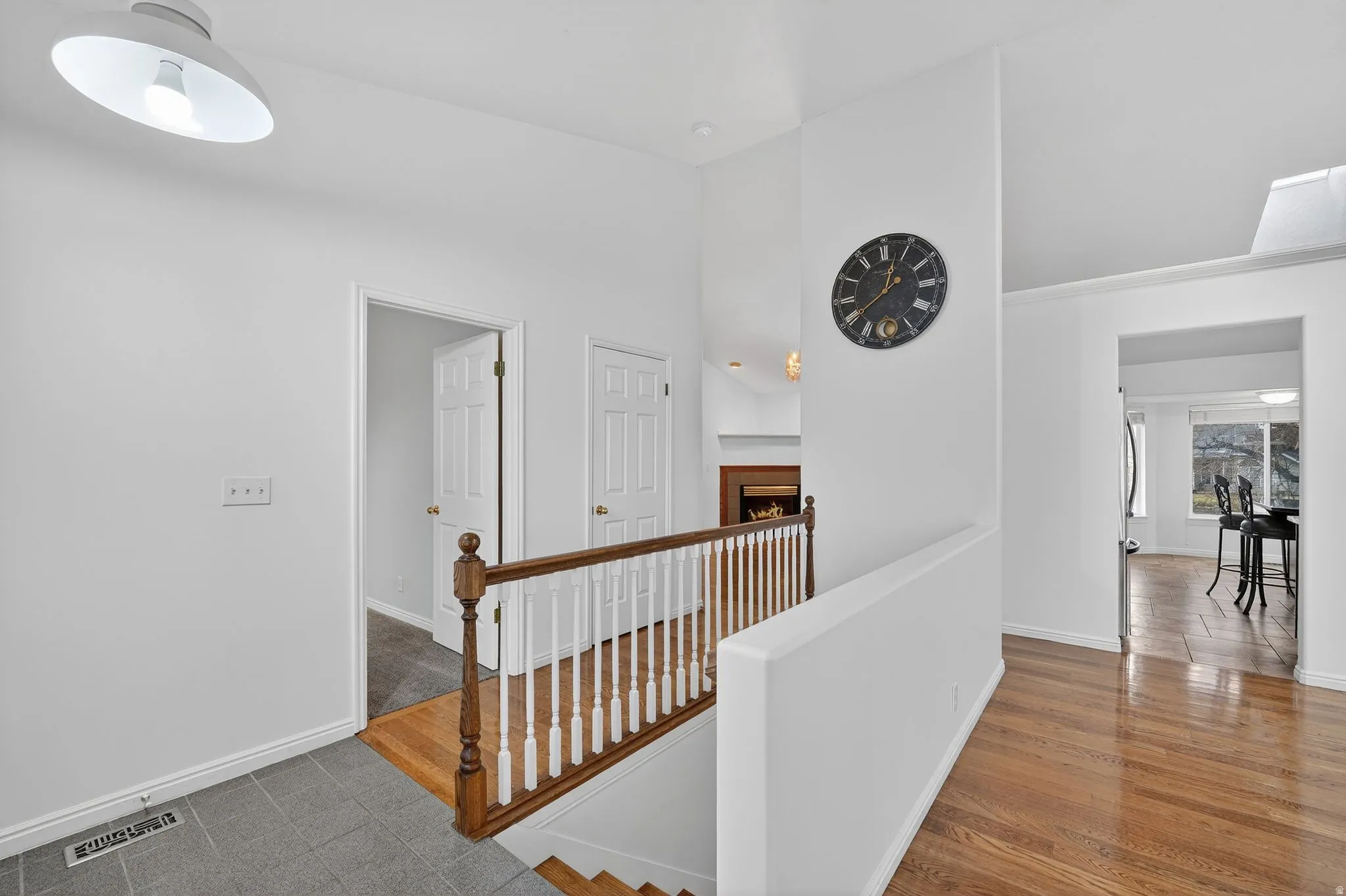 Hall featuring an upstairs landing and wood finished floors