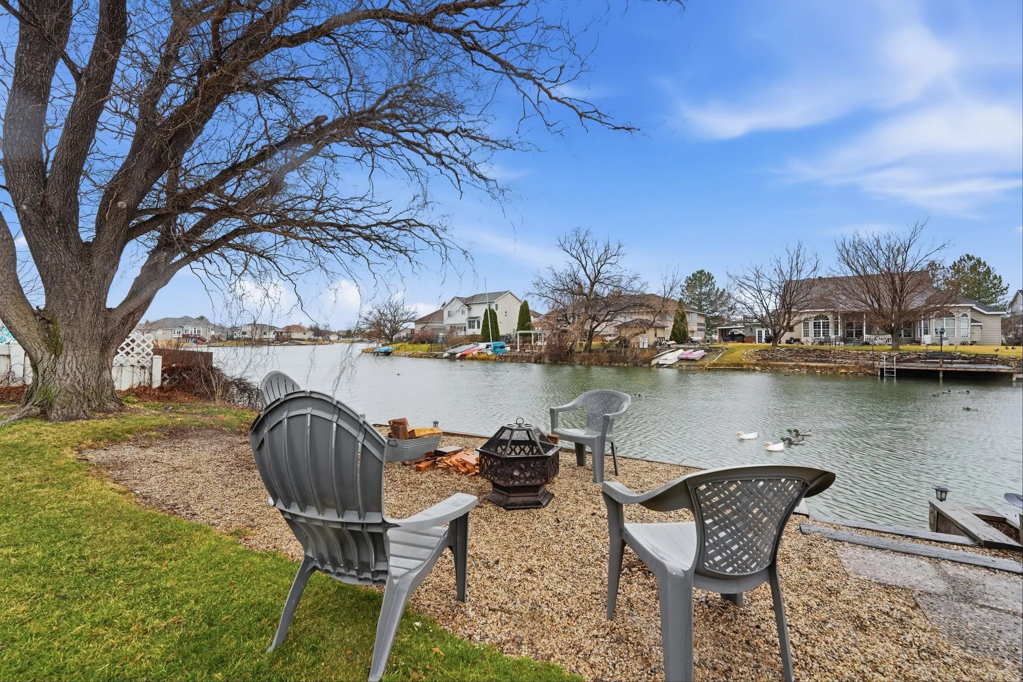 Water view with nearby suburban area and an outdoor fire pit