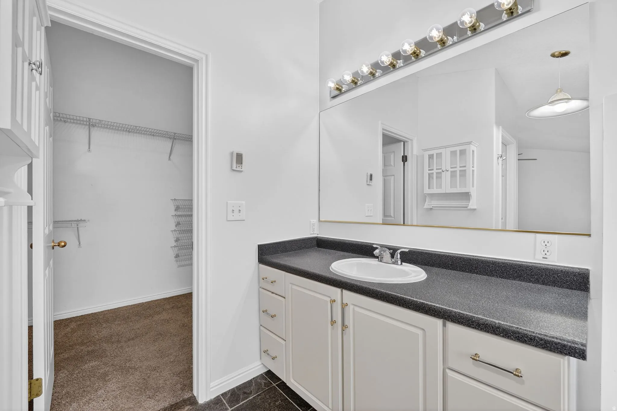 Full bath featuring vanity and a spacious closet