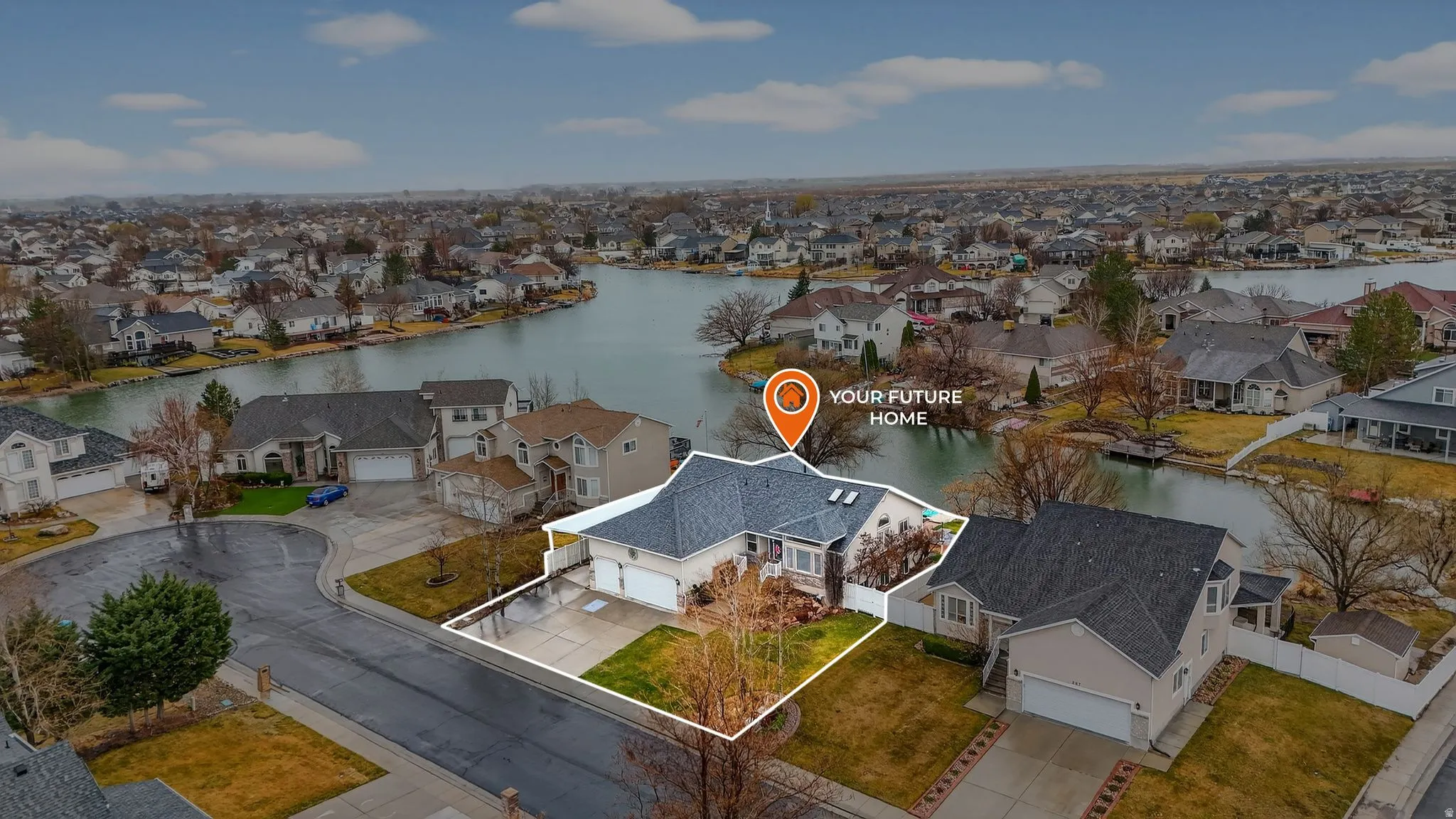 Aerial view of residential area featuring a nearby body of water