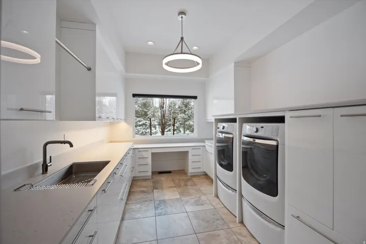 Laundry room featuring washer and clothes dryer, recessed lighting, and cabinet space