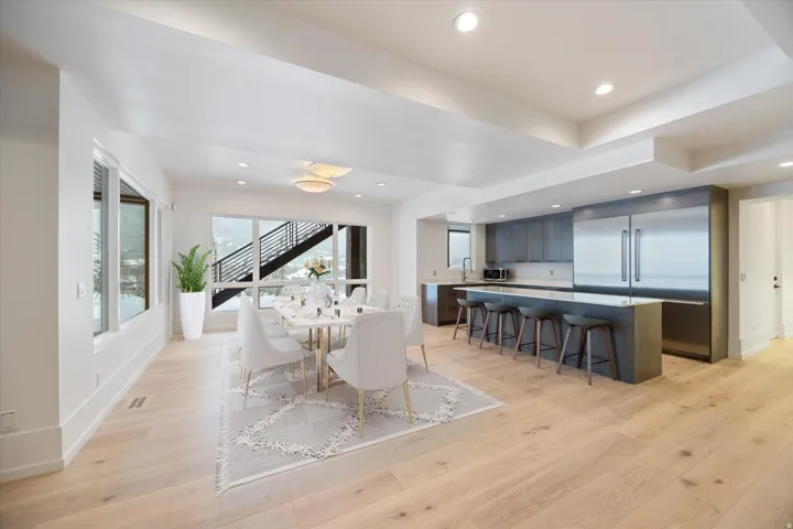 Dining area with light wood-type flooring and recessed lighting