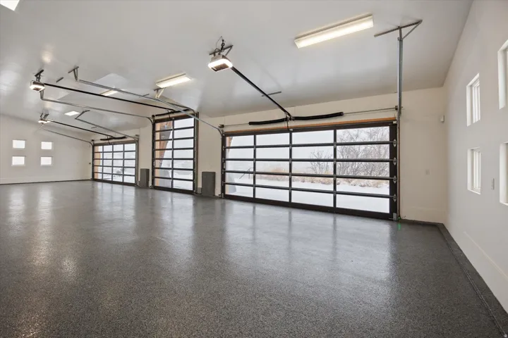 Garage with baseboards and a garage door opener