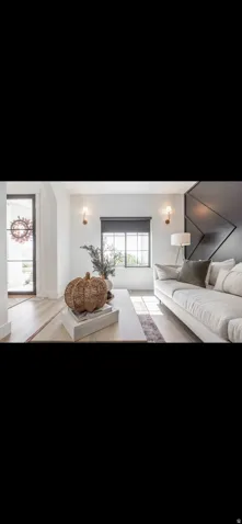 Living area with light wood-type flooring and baseboards