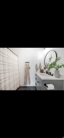 Bathroom featuring vanity and dark wood-style floors