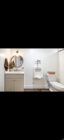 Bathroom with vanity and dark wood-type flooring