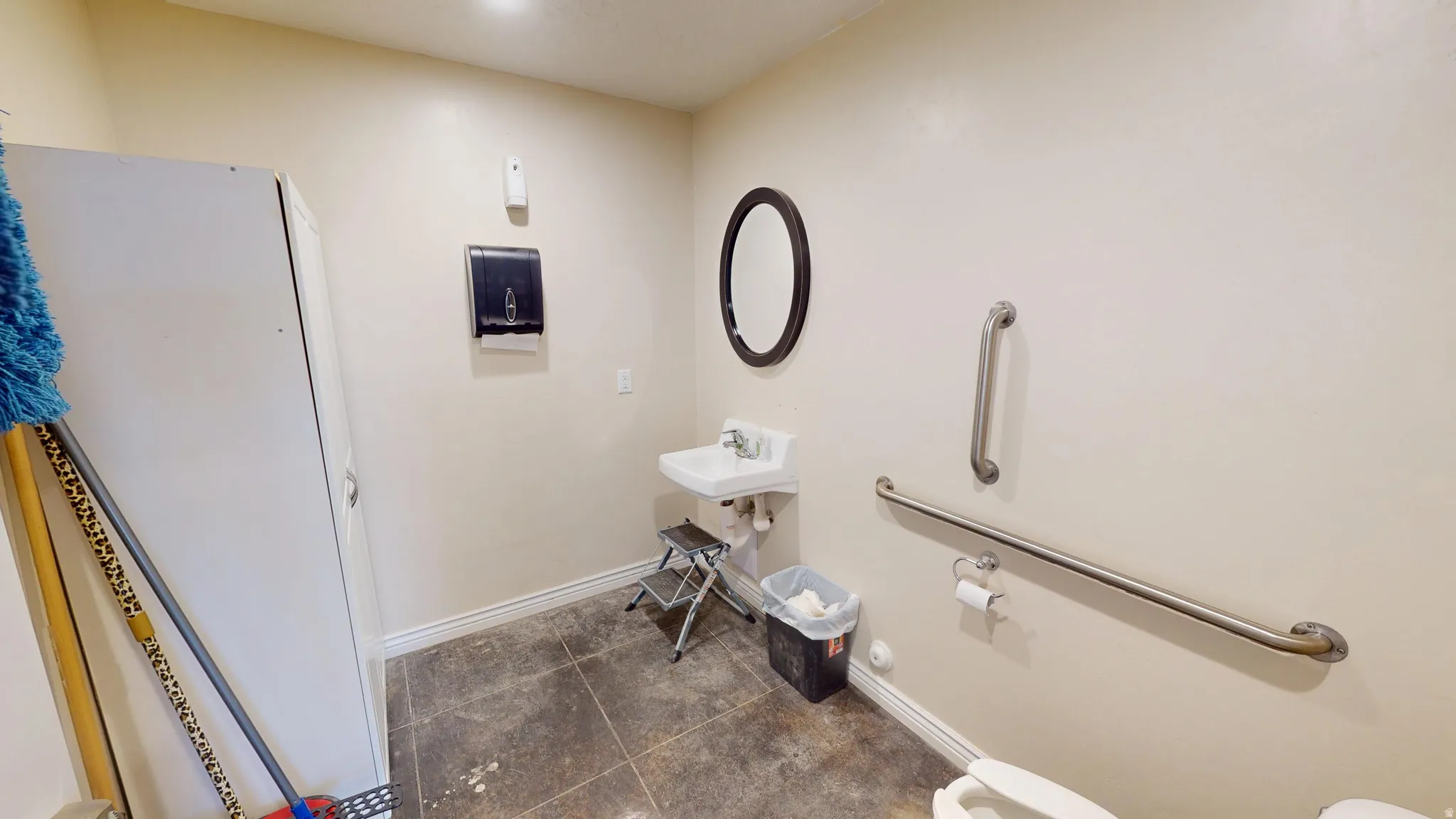 Half bath featuring toilet and a sink