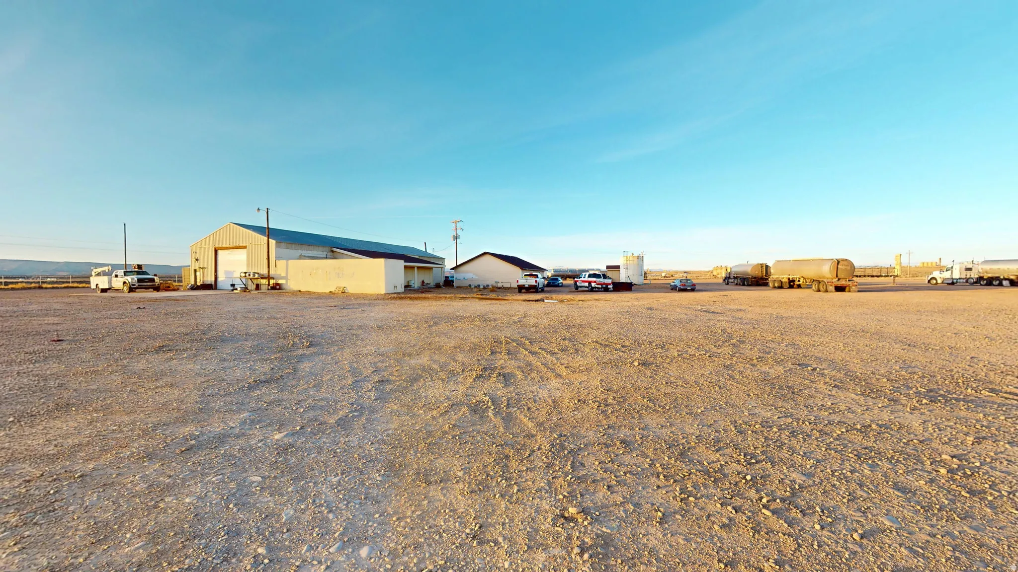 View of yard featuring a garage and an outbuilding