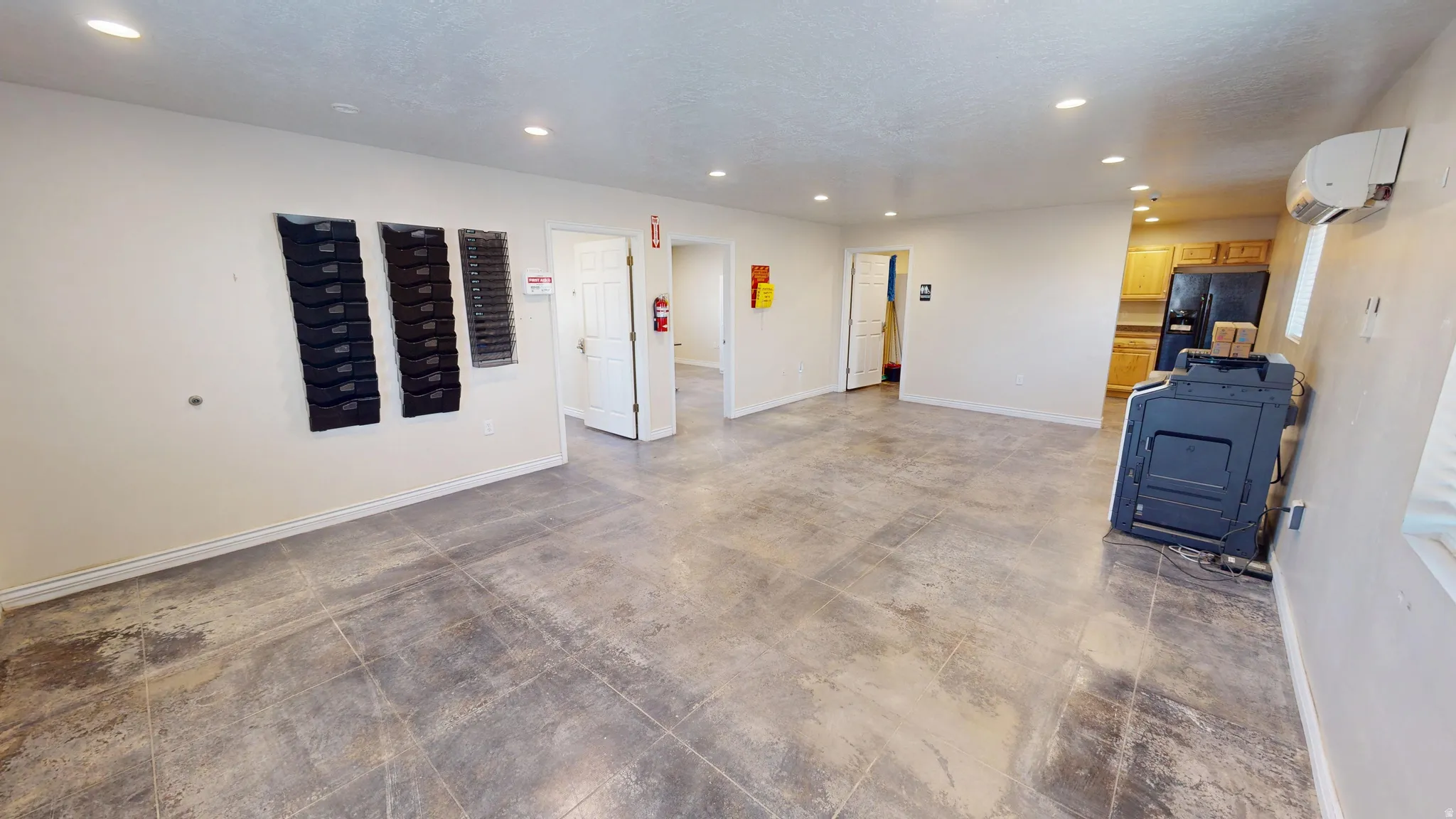 Interior space featuring black fridge and recessed lighting