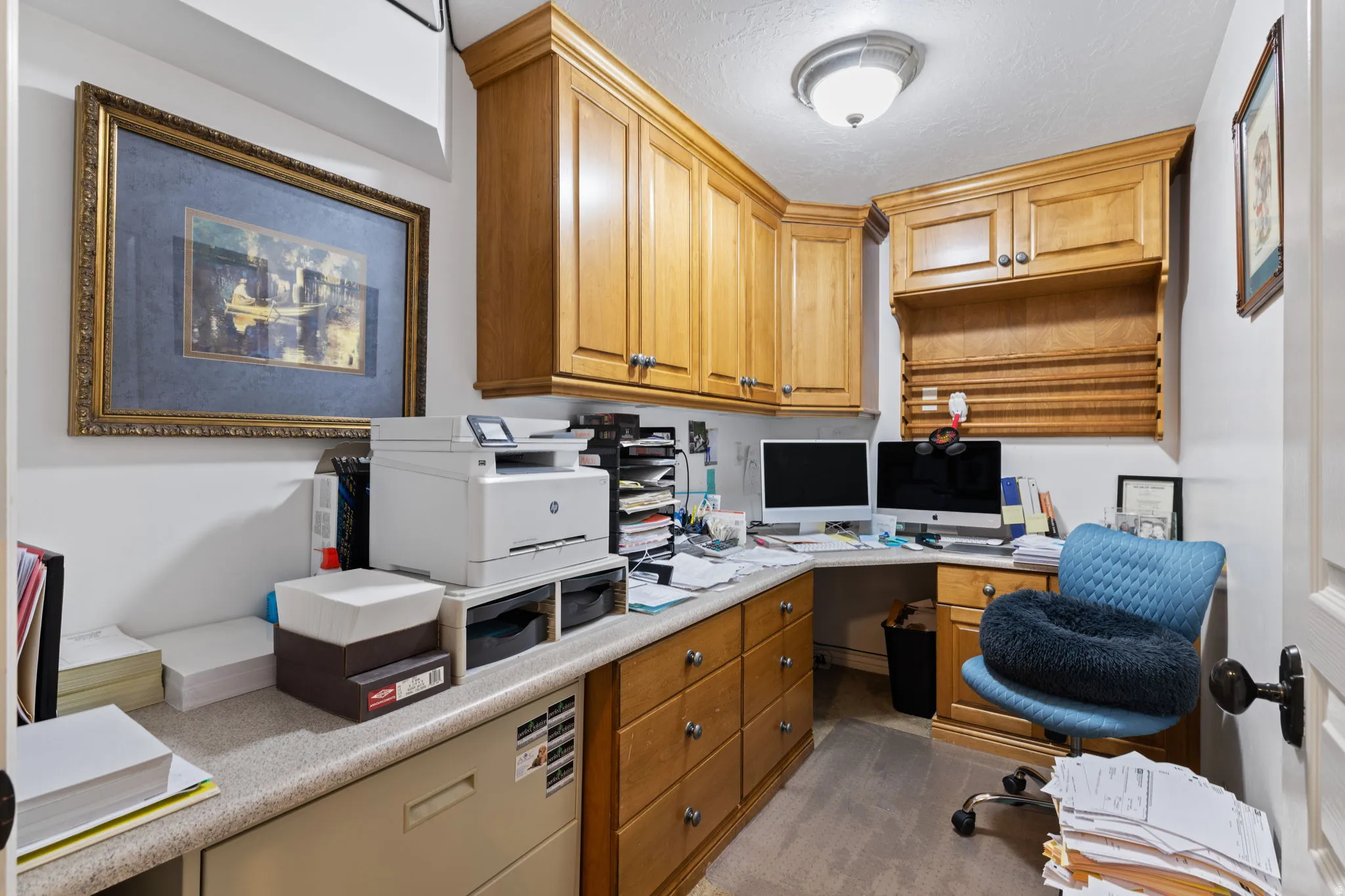 Office area featuring built in study area and a textured ceiling