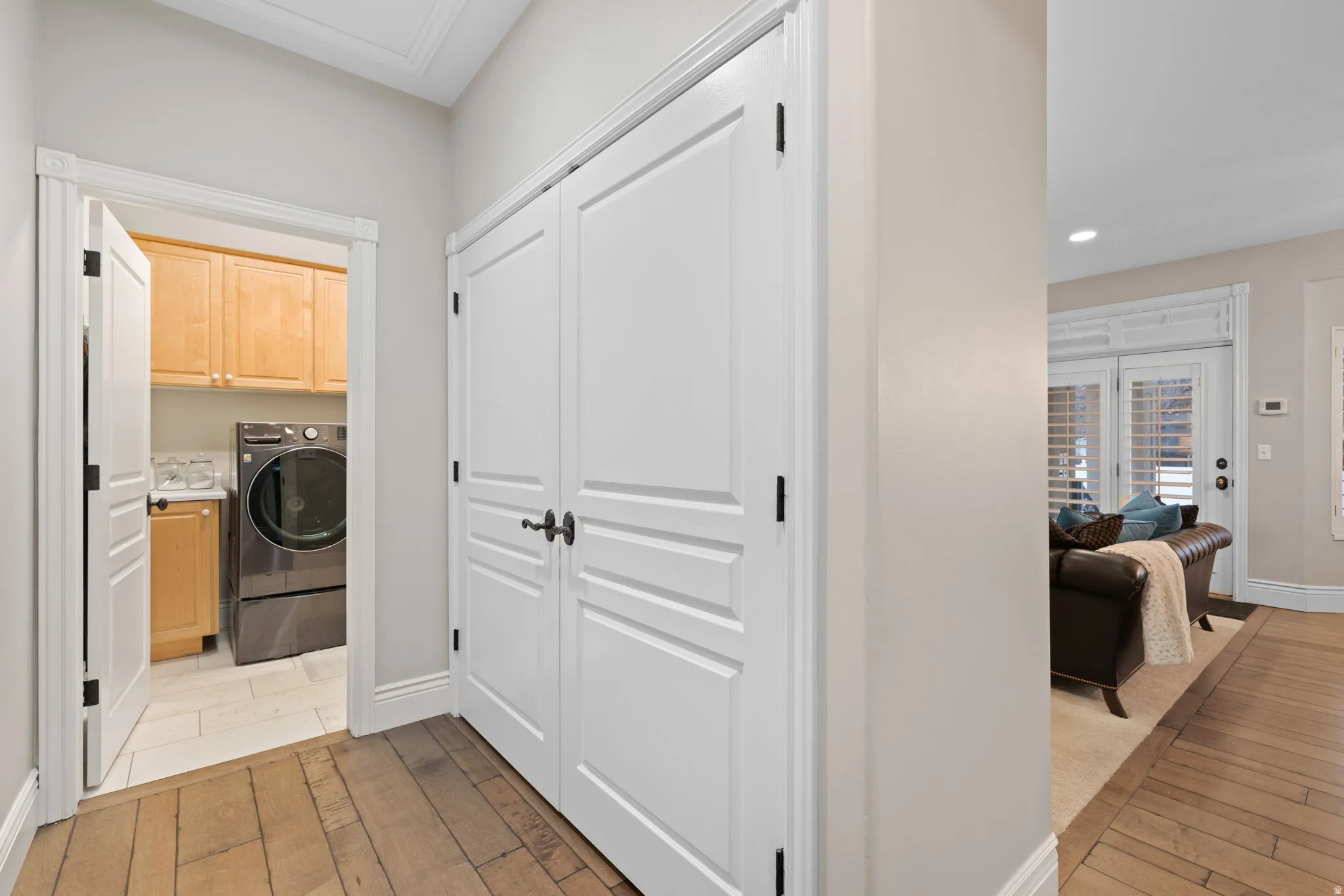 Laundry area featuring cabinet space, light wood-style floors, washer / dryer, and recessed lighting