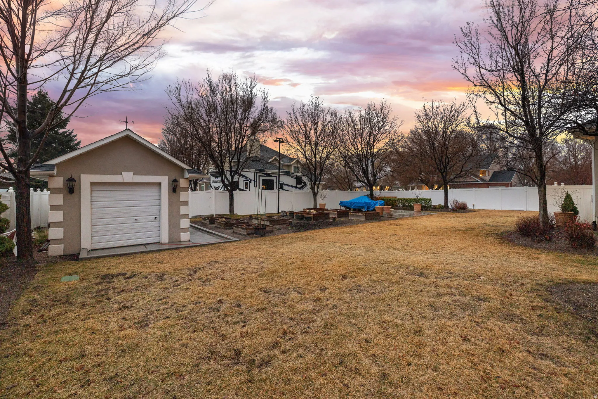 Fenced backyard with an outbuilding