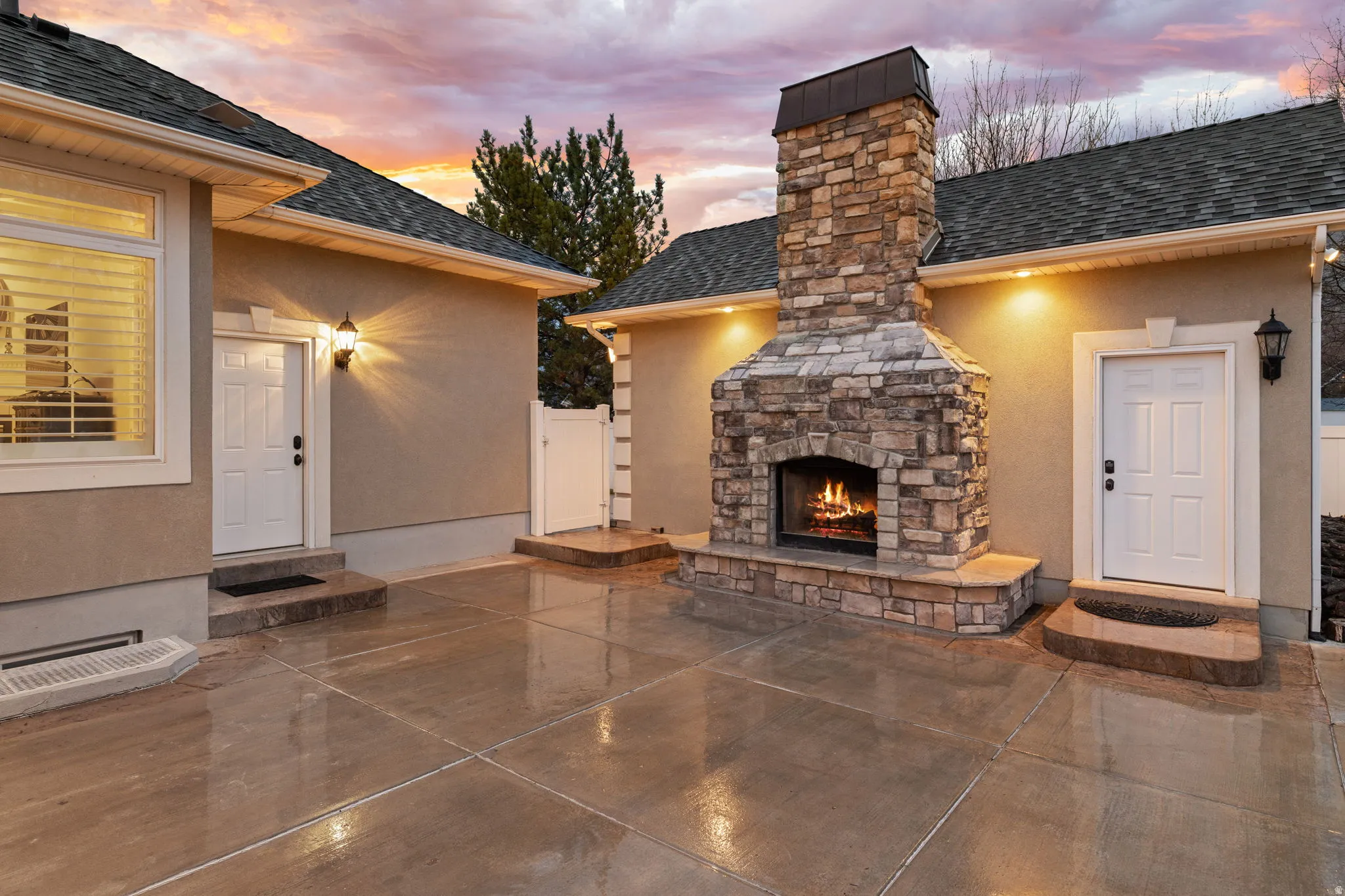 View of patio / terrace featuring an outdoor stone fireplace