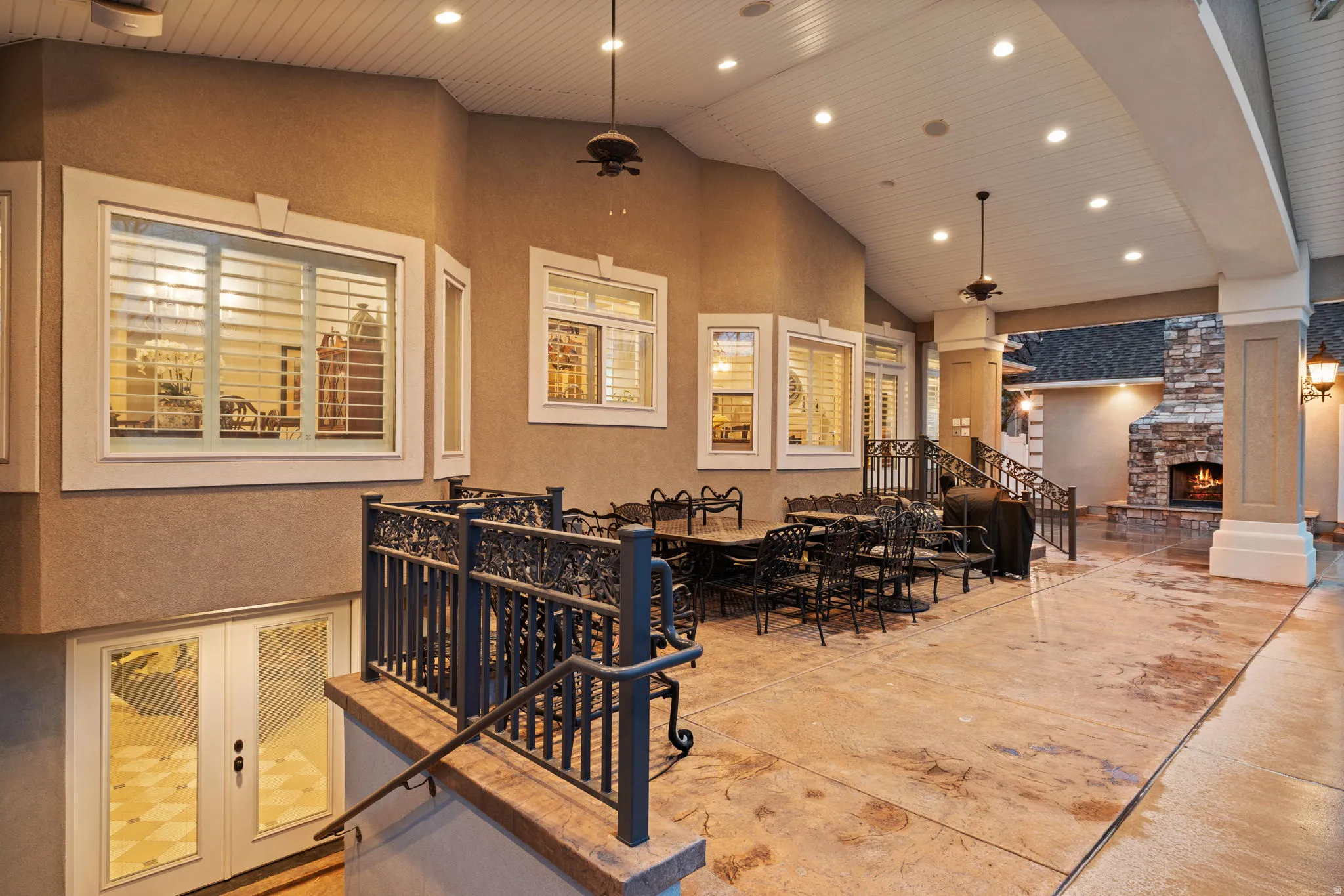 View of patio / terrace with an outdoor stone fireplace and french doors