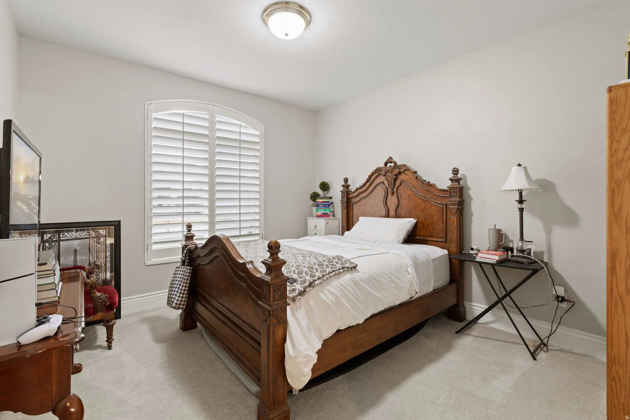 Bedroom with light colored carpet and baseboards
