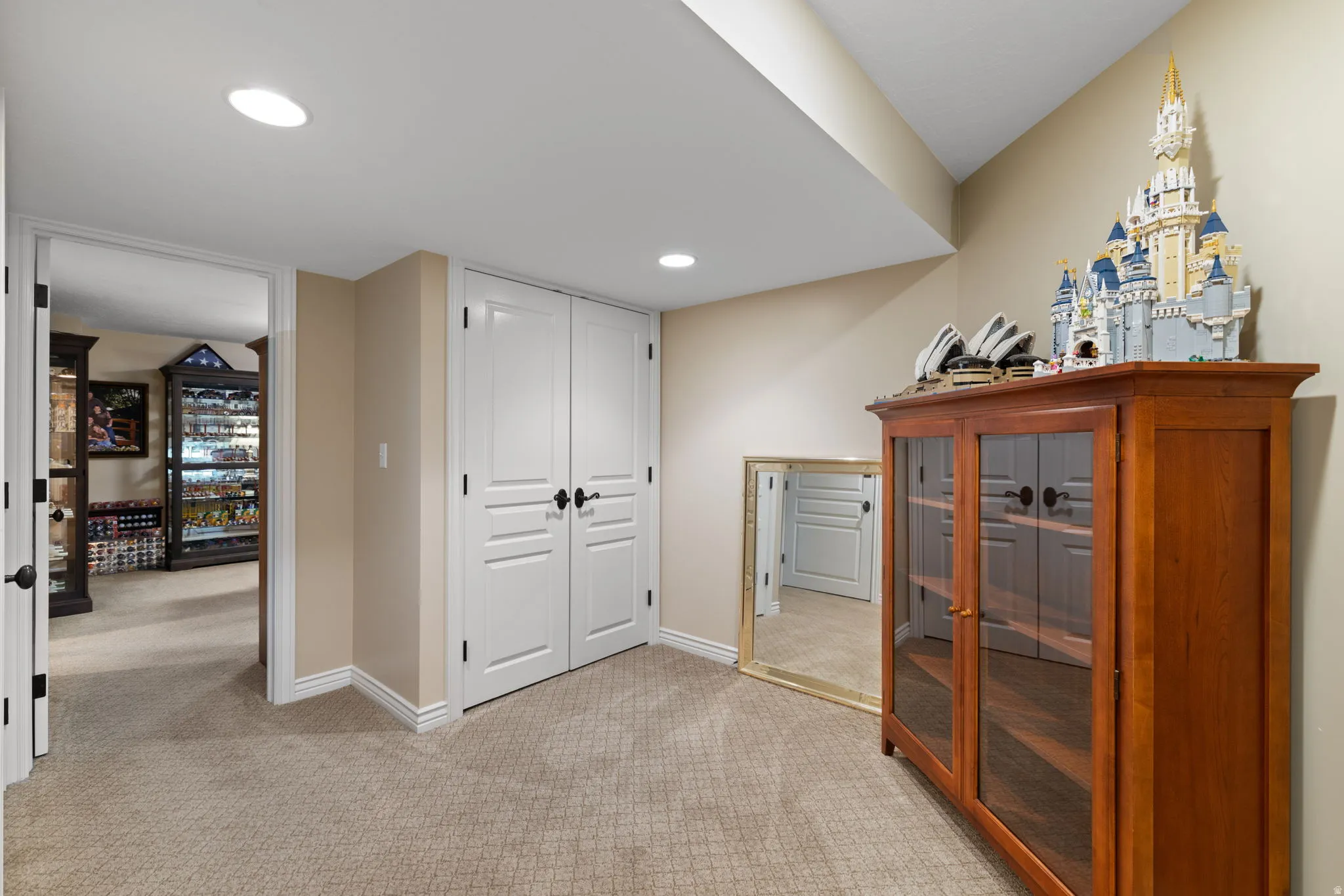 Bedroom with a closet, light colored carpet, and recessed lighting