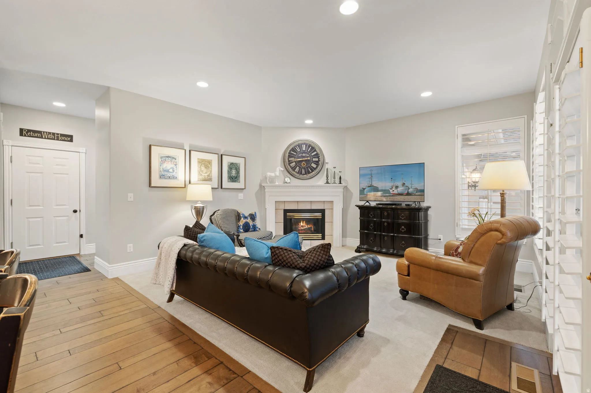 Living room featuring a fireplace, light wood finished floors, and recessed lighting