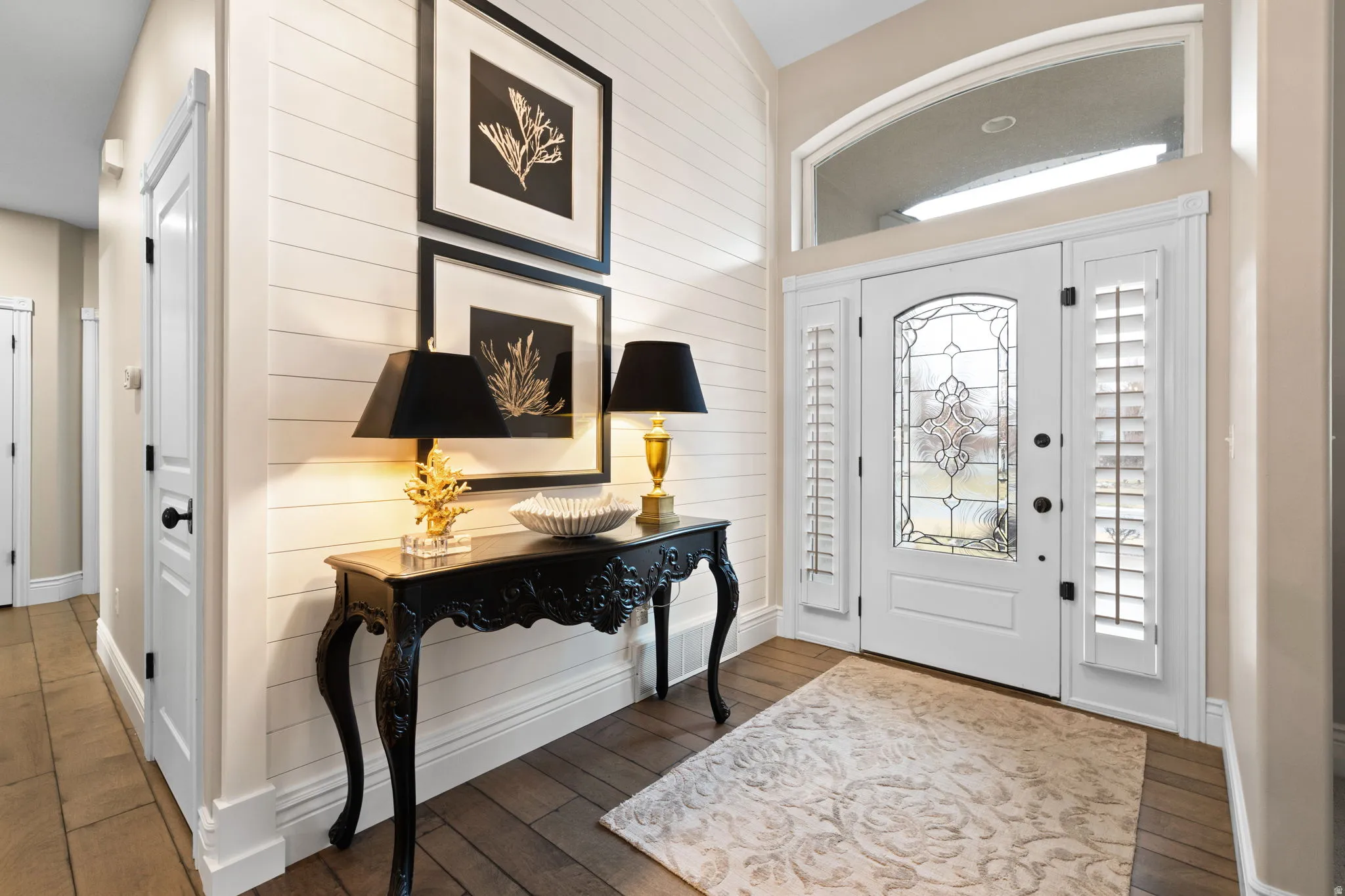 Entrance foyer featuring wood-type flooring and wood walls