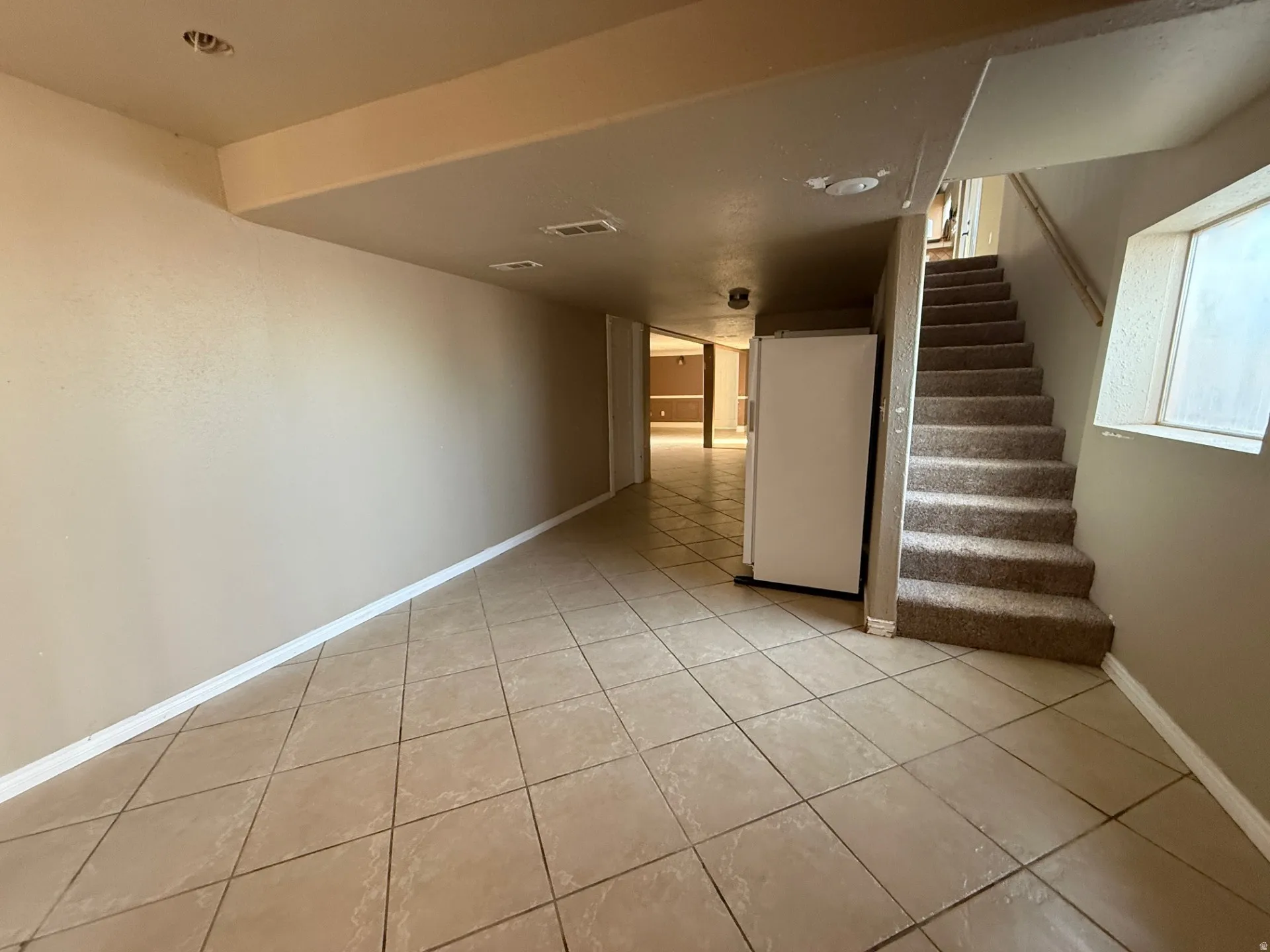 Staircase featuring tile patterned floors and baseboards