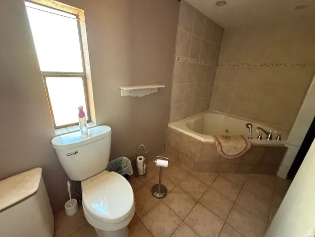 Bathroom featuring a jetted tub and tile patterned floors