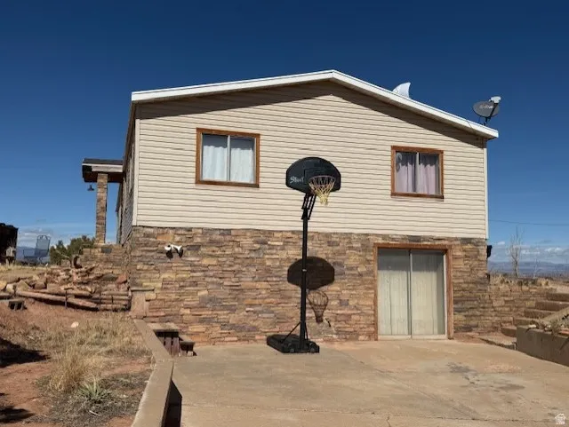 View of property exterior featuring stone siding