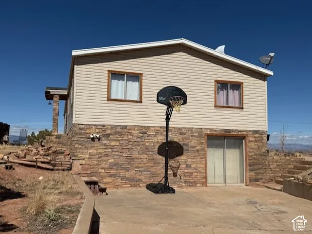 View of property exterior featuring stone siding