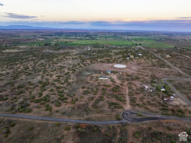 Expansive open land featuring a visible road network and scattered low-lying vegetation