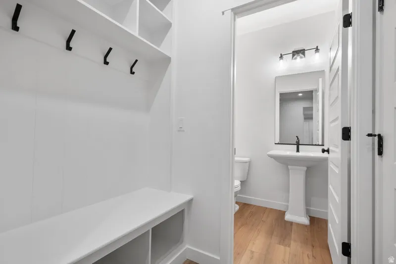 Mudroom with light wood finished floors and baseboards