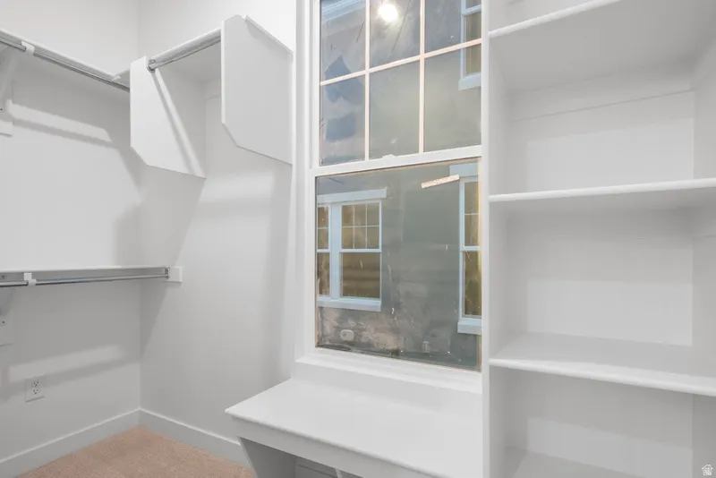 Walk in closet featuring carpet flooring