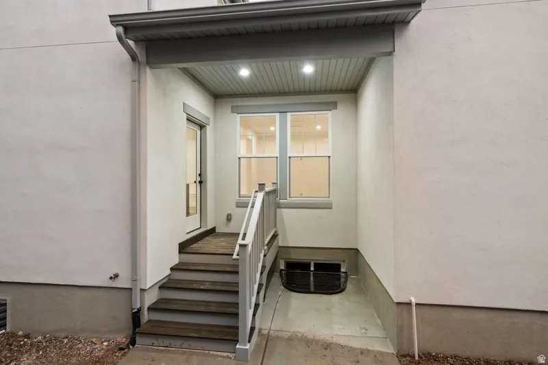 Entrance to property with stucco siding