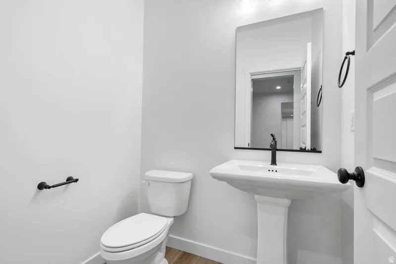 Bathroom featuring baseboards and light wood finished floors