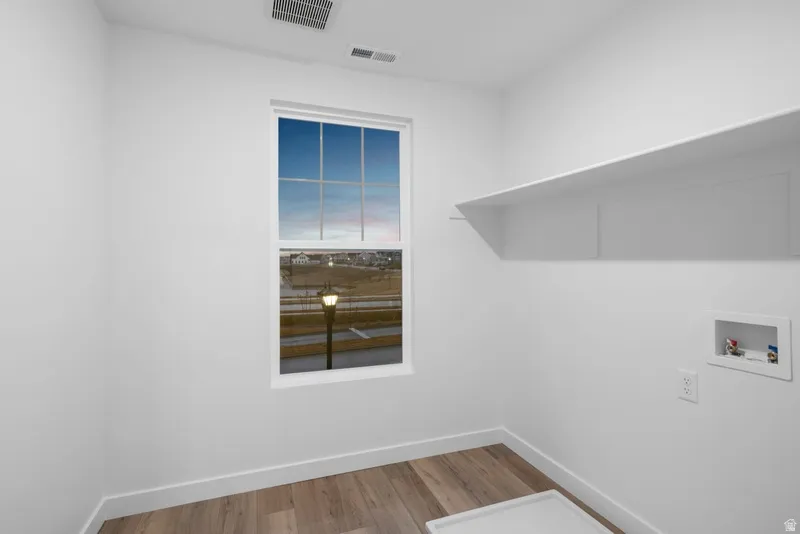 Laundry room featuring light wood-type flooring and hookup for a washing machine
