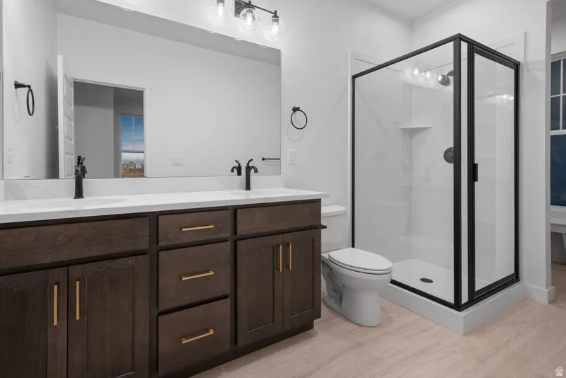 Bathroom with double vanity and a shower stall