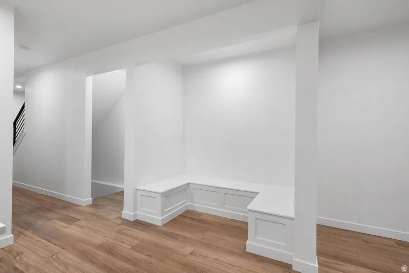 Mudroom featuring light wood-style floors and baseboards