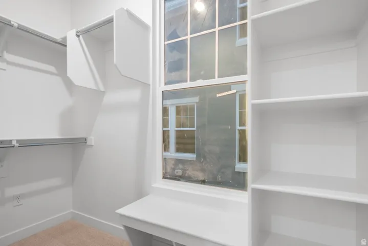 Walk in closet featuring carpet flooring