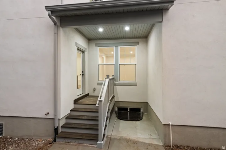Entrance to property with stucco siding