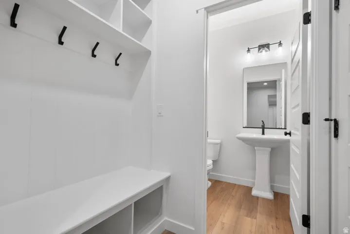 Mudroom with light wood finished floors and baseboards