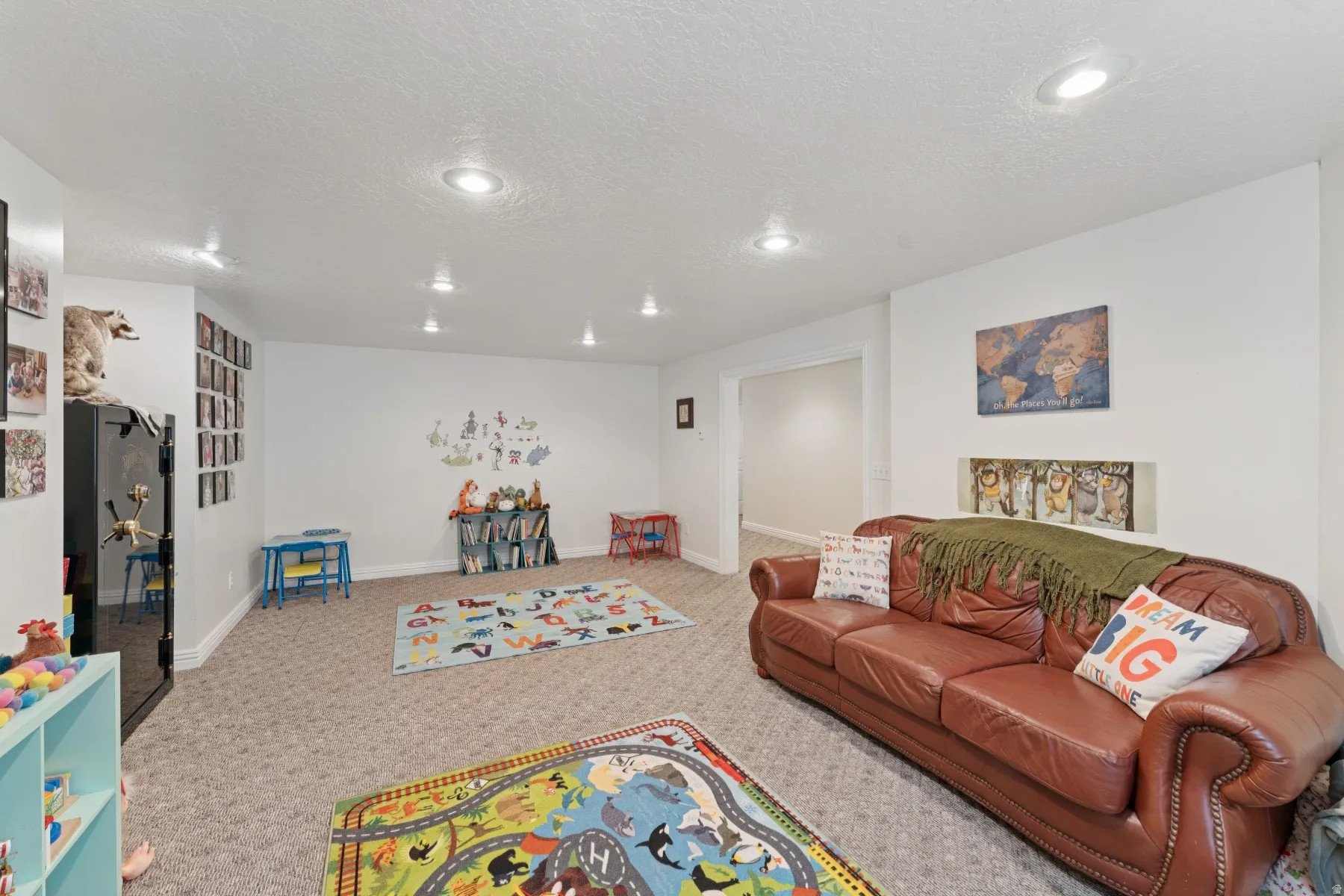 Playroom with carpet floors and a textured ceiling