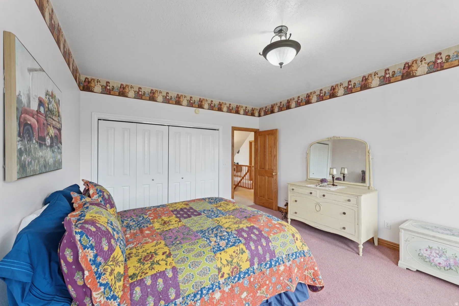 Carpeted bedroom featuring a closet