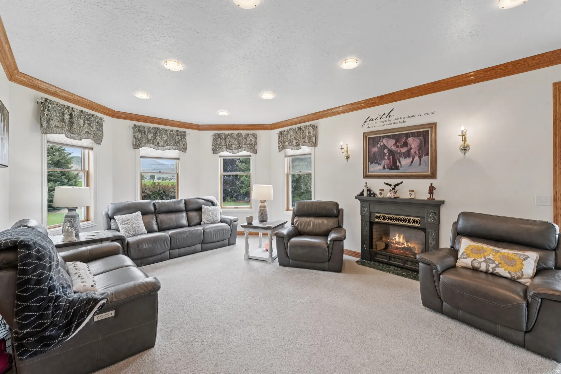 Living room featuring carpet, a glass covered fireplace, crown molding, and a textured ceiling