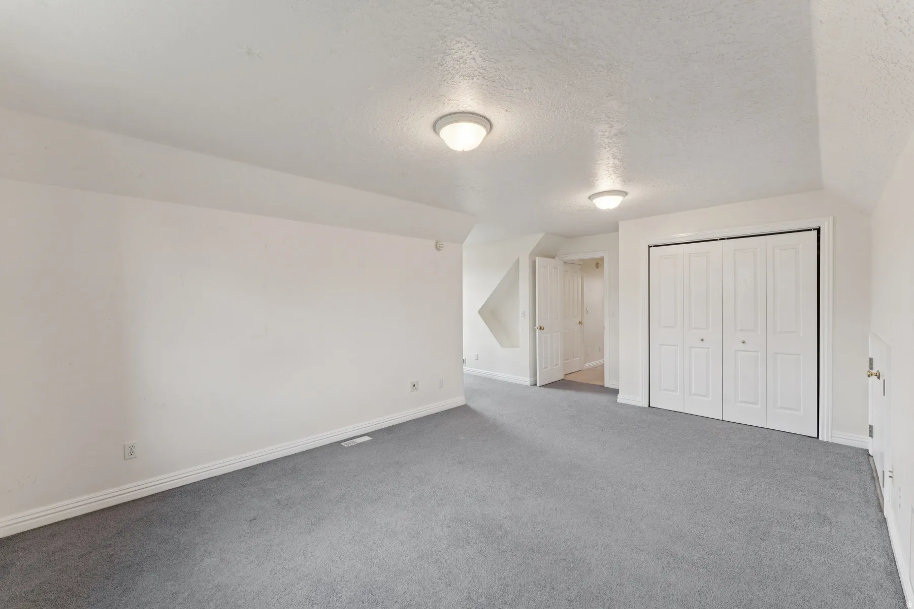 Bonus room with carpet floors and baseboards