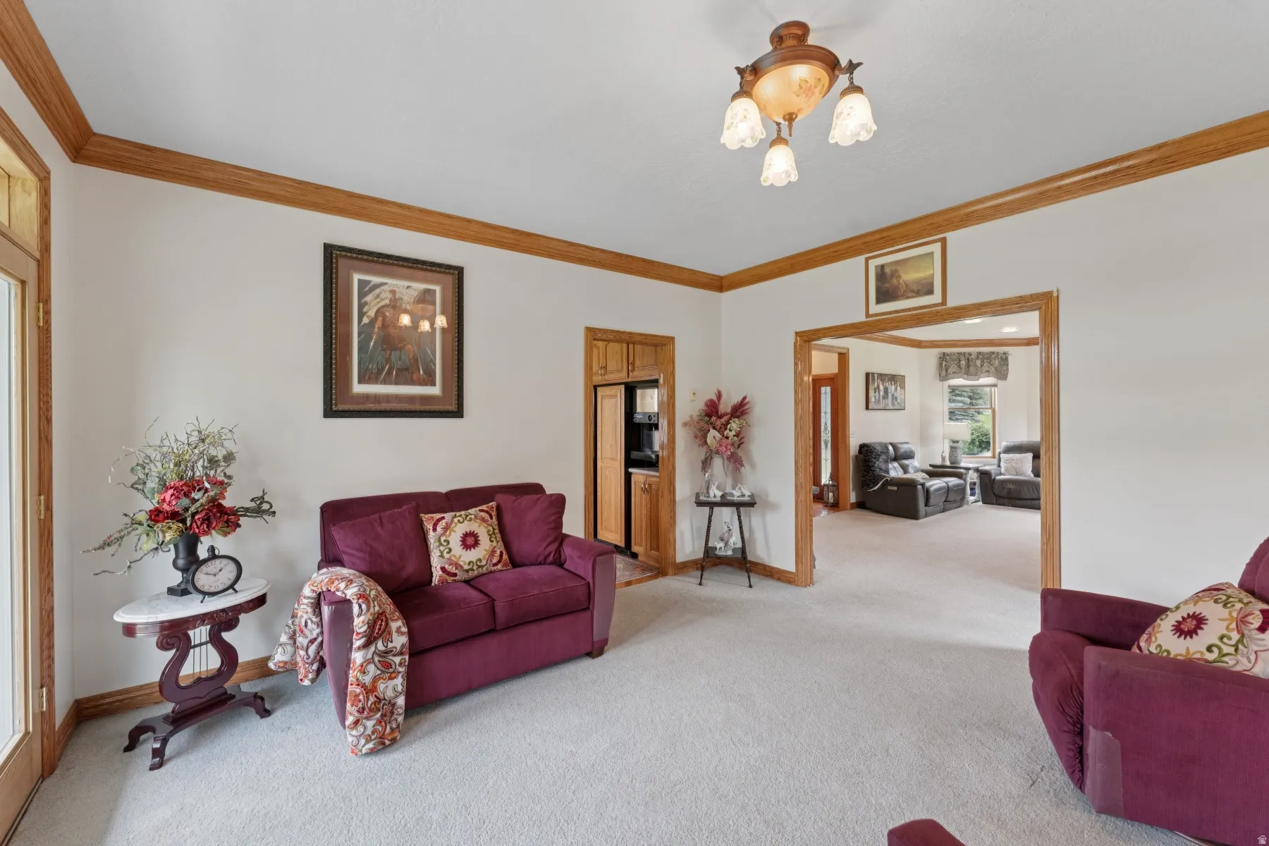 Living room featuring carpet and crown molding